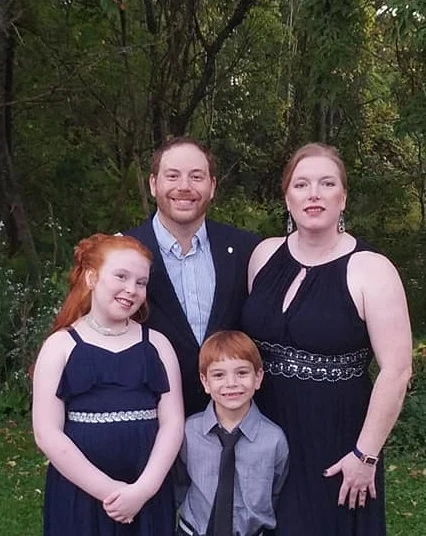 Drs. Heather and Evan Sandler with their family, as pictured on the clinic website
